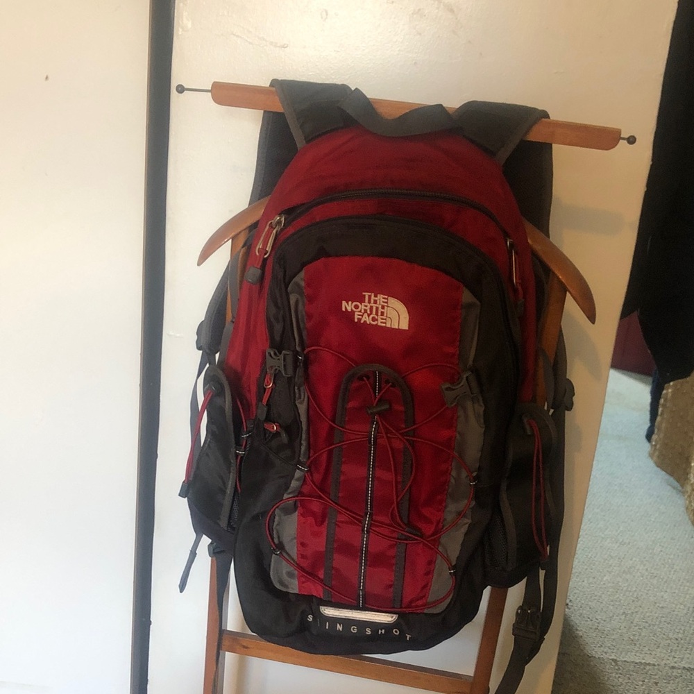 The North Face Slingshot padded backpack with multi drawstrings & multi compart